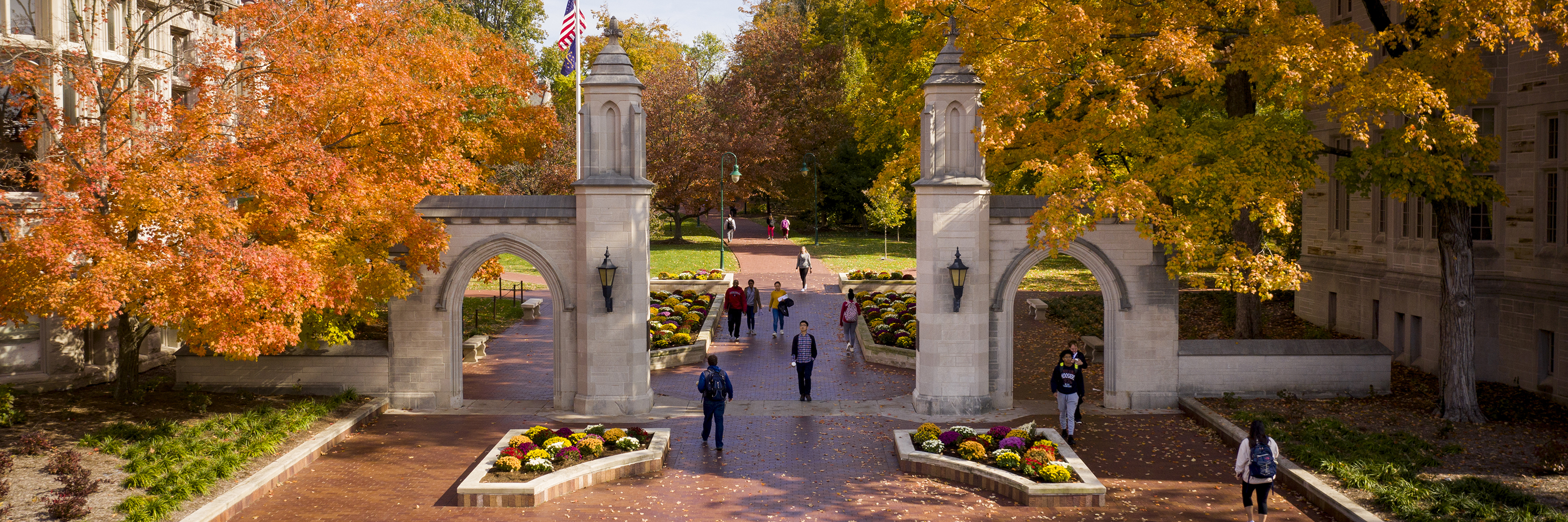 Students walk through the Sample Gates in the fall on the Indiana University Bloomington campus.