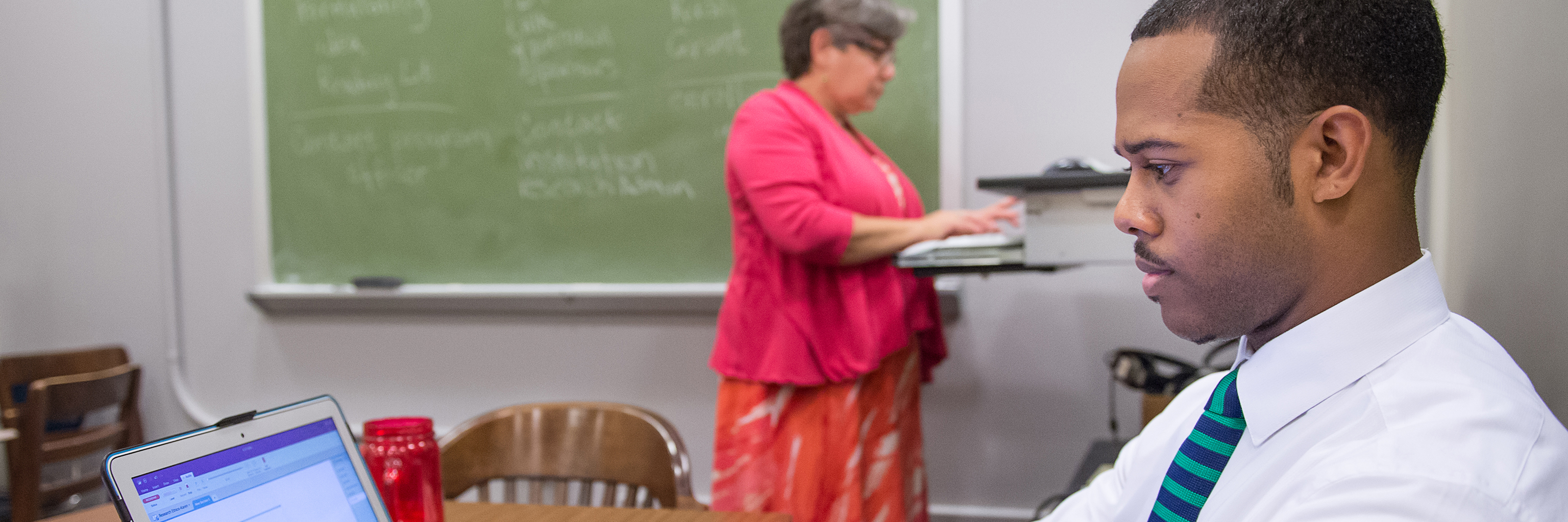 Department of Speech and Hearing student takes notes in classroom.