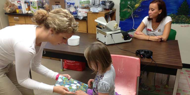 students work with child